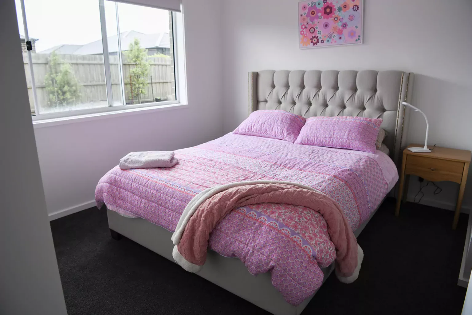 Bedroom with bed and pink bed sheets
