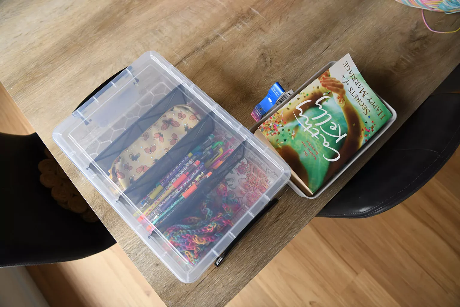 A book and pens on a table