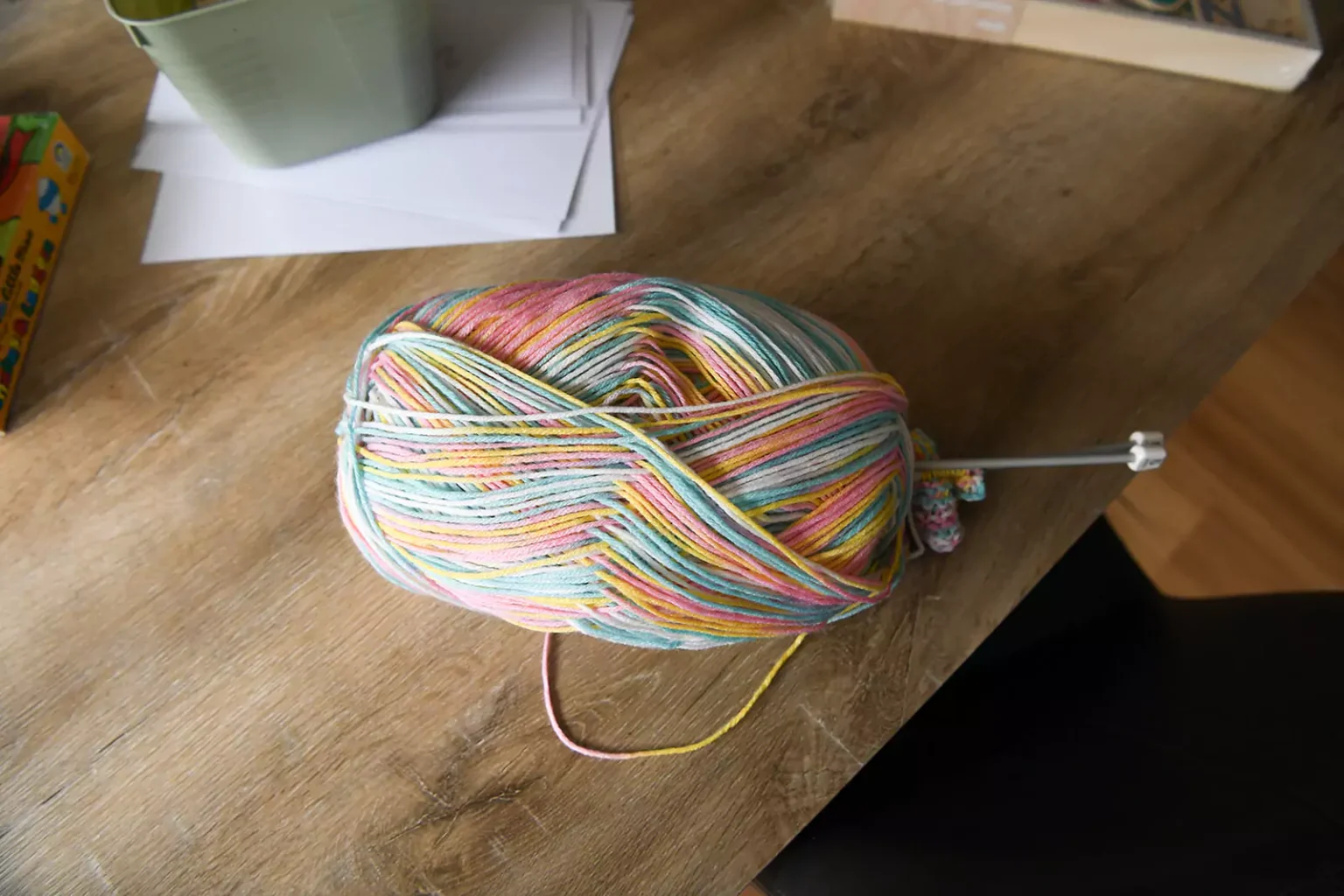 Yarn on a table with knitting needles