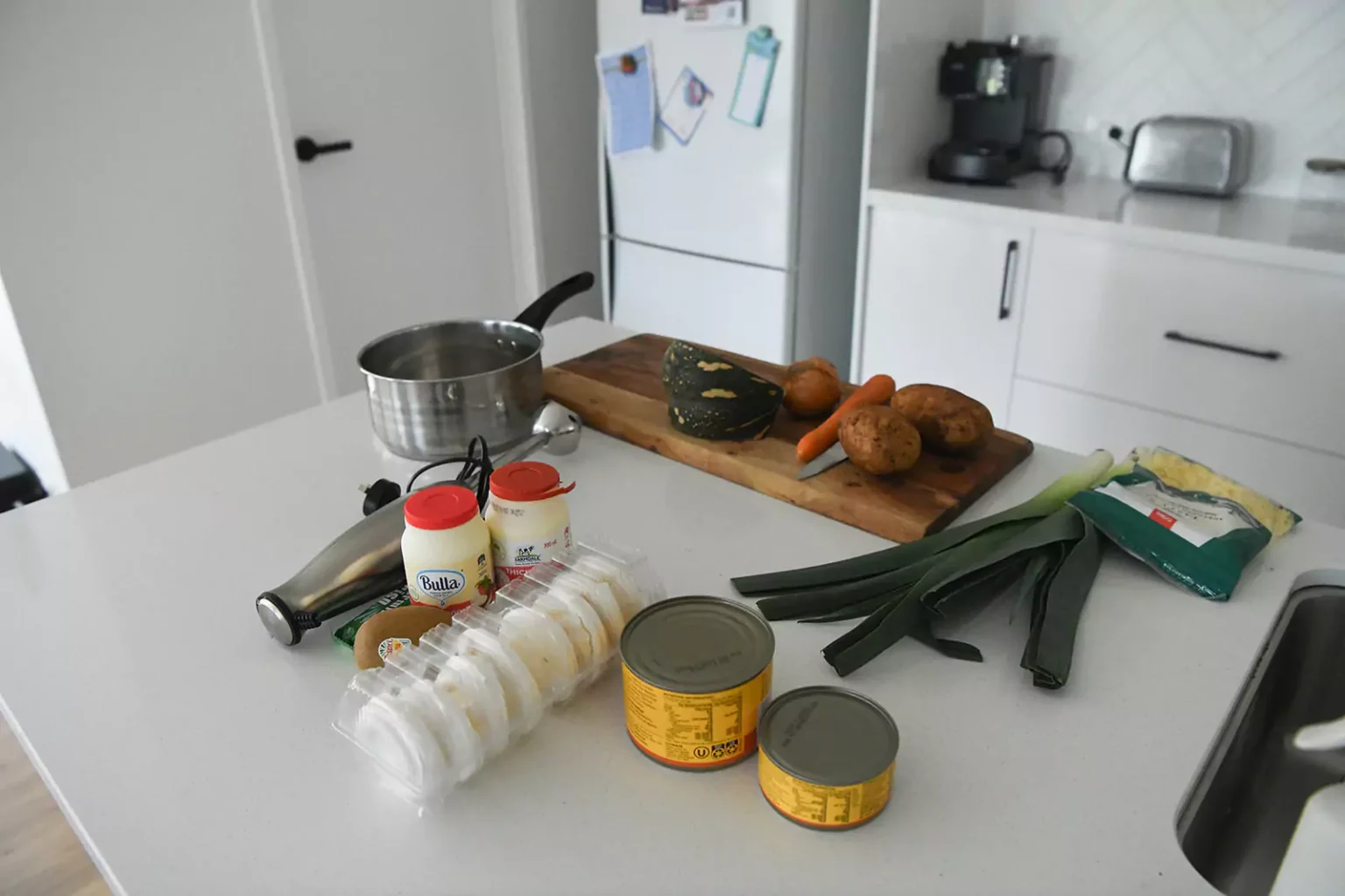 Kitchen table with food and chopping board