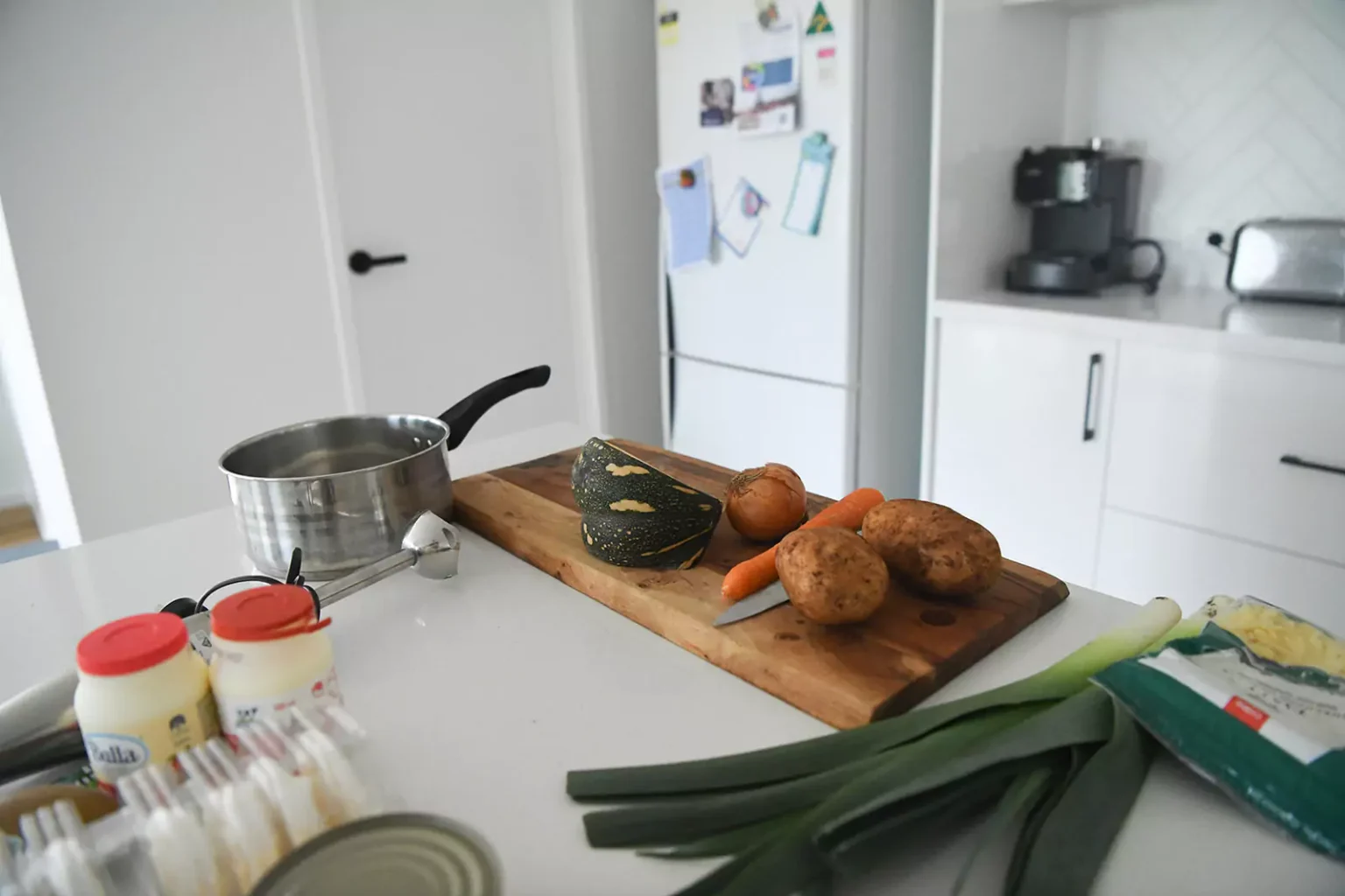 Kitchen table with food and chopping board